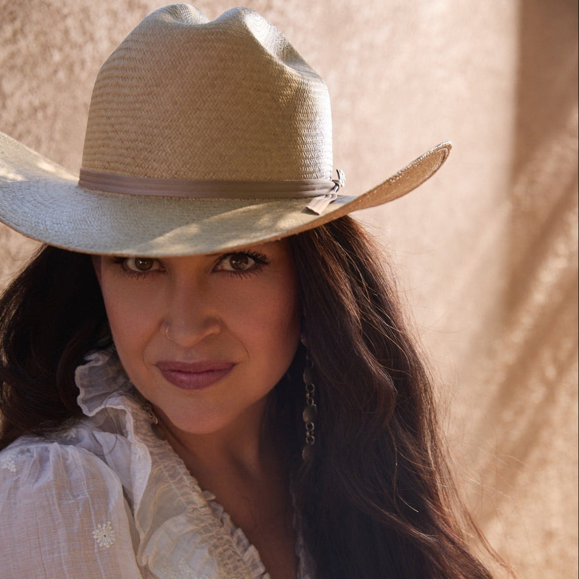 Unisex styling of The Wrangler western straw hat in Dust by Storm, featuring a classic cattleman crease on a female model