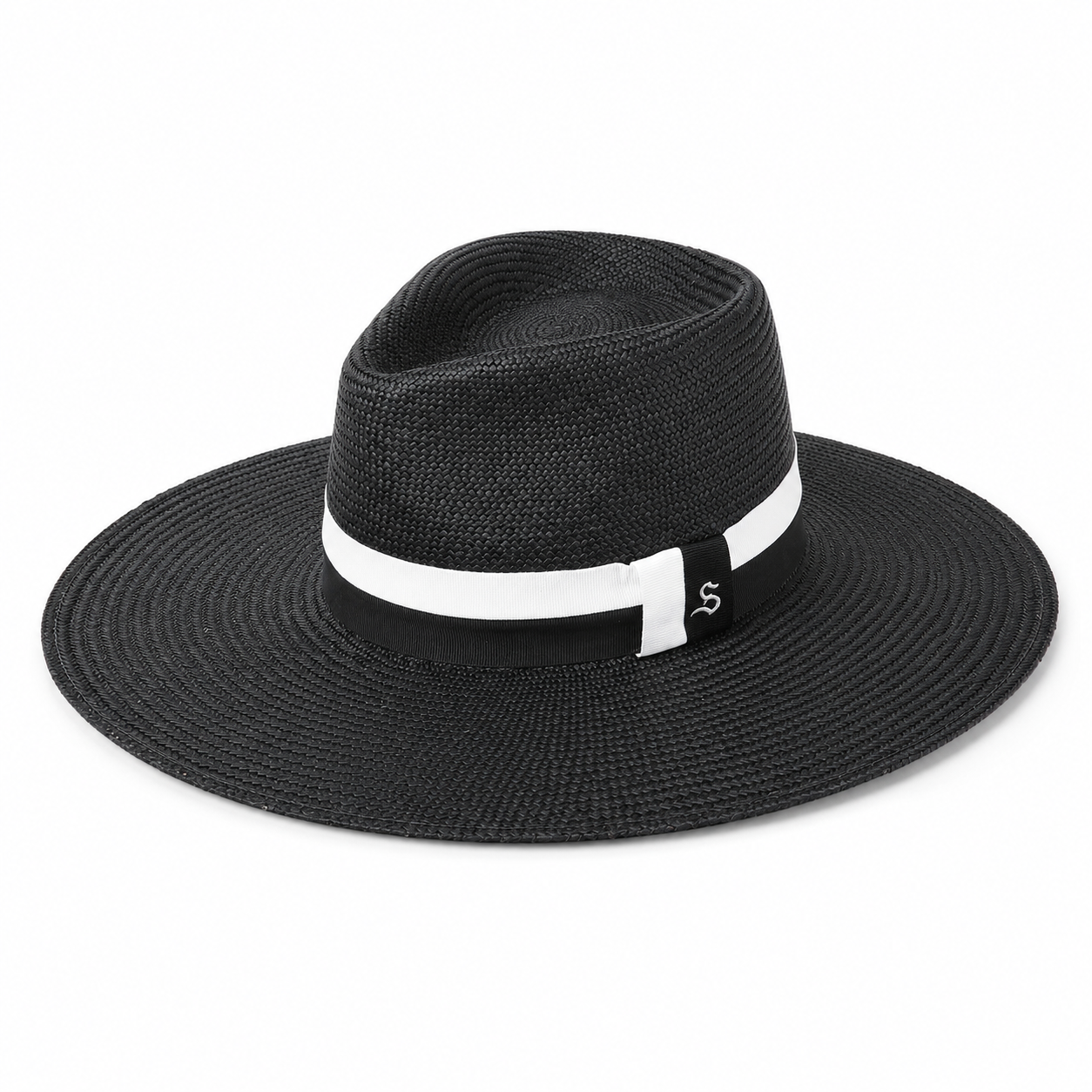 The frances black wide-brim Ecuadorian straw sunhat by Storm by Montecristi, featuring a contrast white and black, hand-stitched grosgrain ribbon with a sterling silver logo.