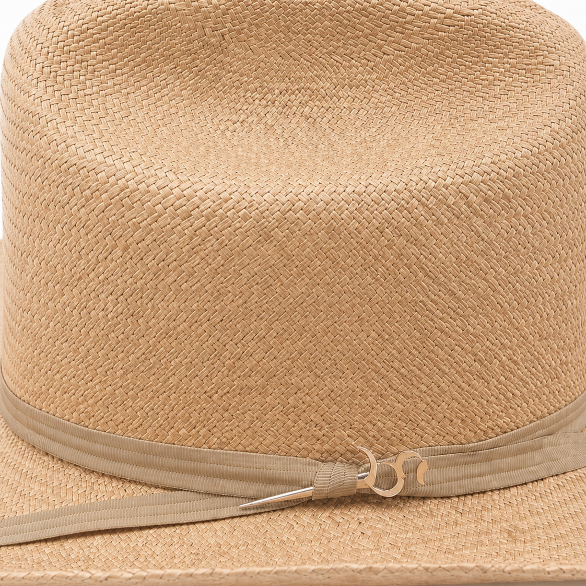Close-up of the Belly colored 3-cord tied band on The Wrangler hat, featuring the hand-forged sterling silver logo dagger pin.